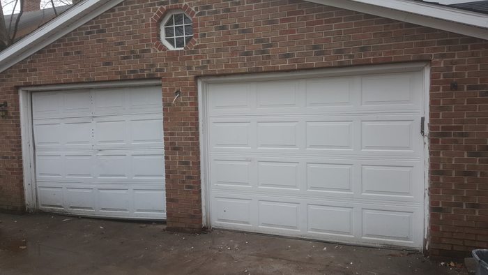 Old worn garage doors — before replacement