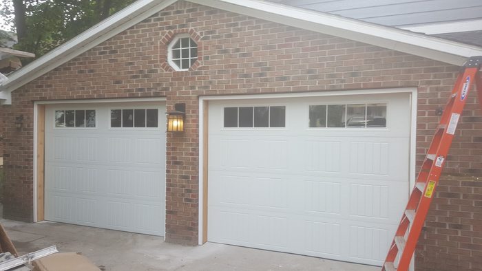 New garage doors with window inserts — after